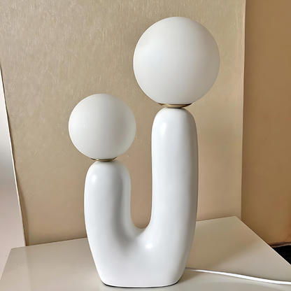 Dvoukulová pryskyřičná stolní lampa v jemných pastelových odstínech